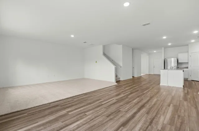 a view of a kitchen with wooden floor and a sink