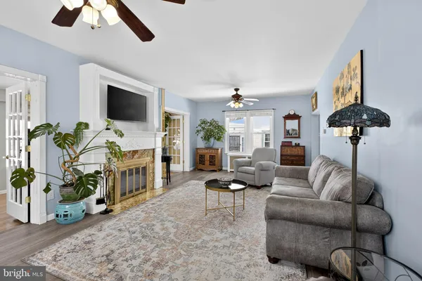 a living room with furniture a chandelier and a flat screen tv
