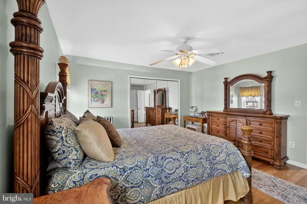 a bedroom with a large bed and a dresser