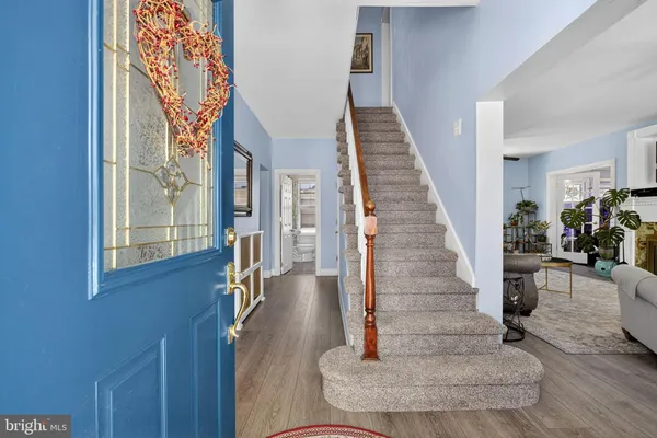 a view of entryway and hall with wooden floor