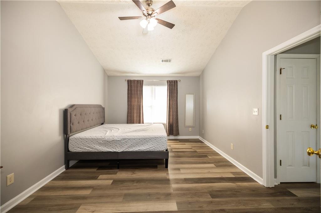 599 Rivulett Court Lawrenceville, GA 30043 - Photo 15 of 31 a bedroom with a bed and window