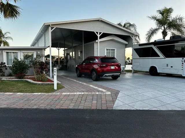 a car parked in front of a house and a yard