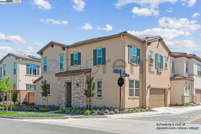 a front view of a house with a garden and plants