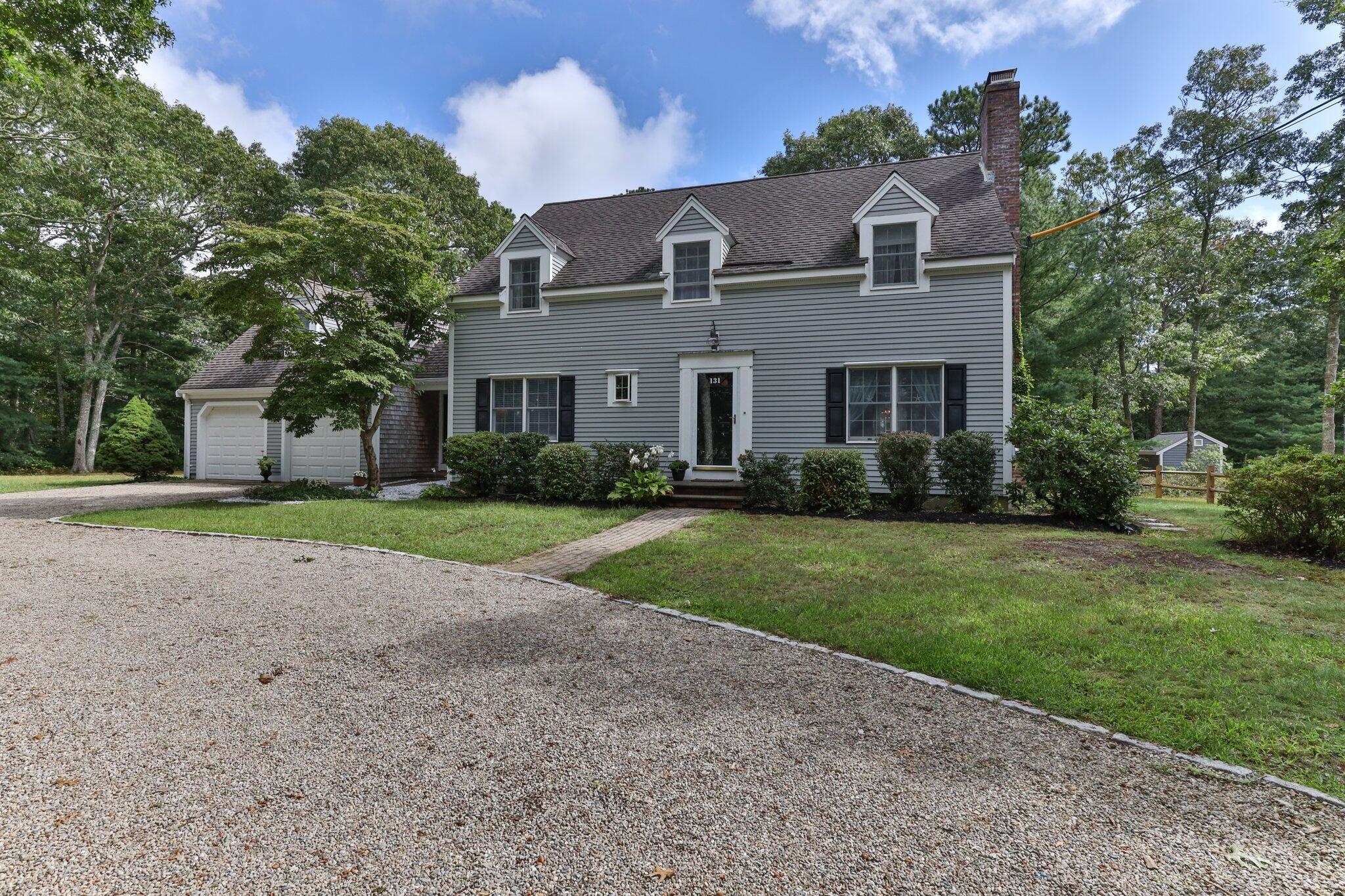 131 Clamshell Cove Road Cotuit, MA 02635 - Photo 1 of 67 a front view of house with yard and green space