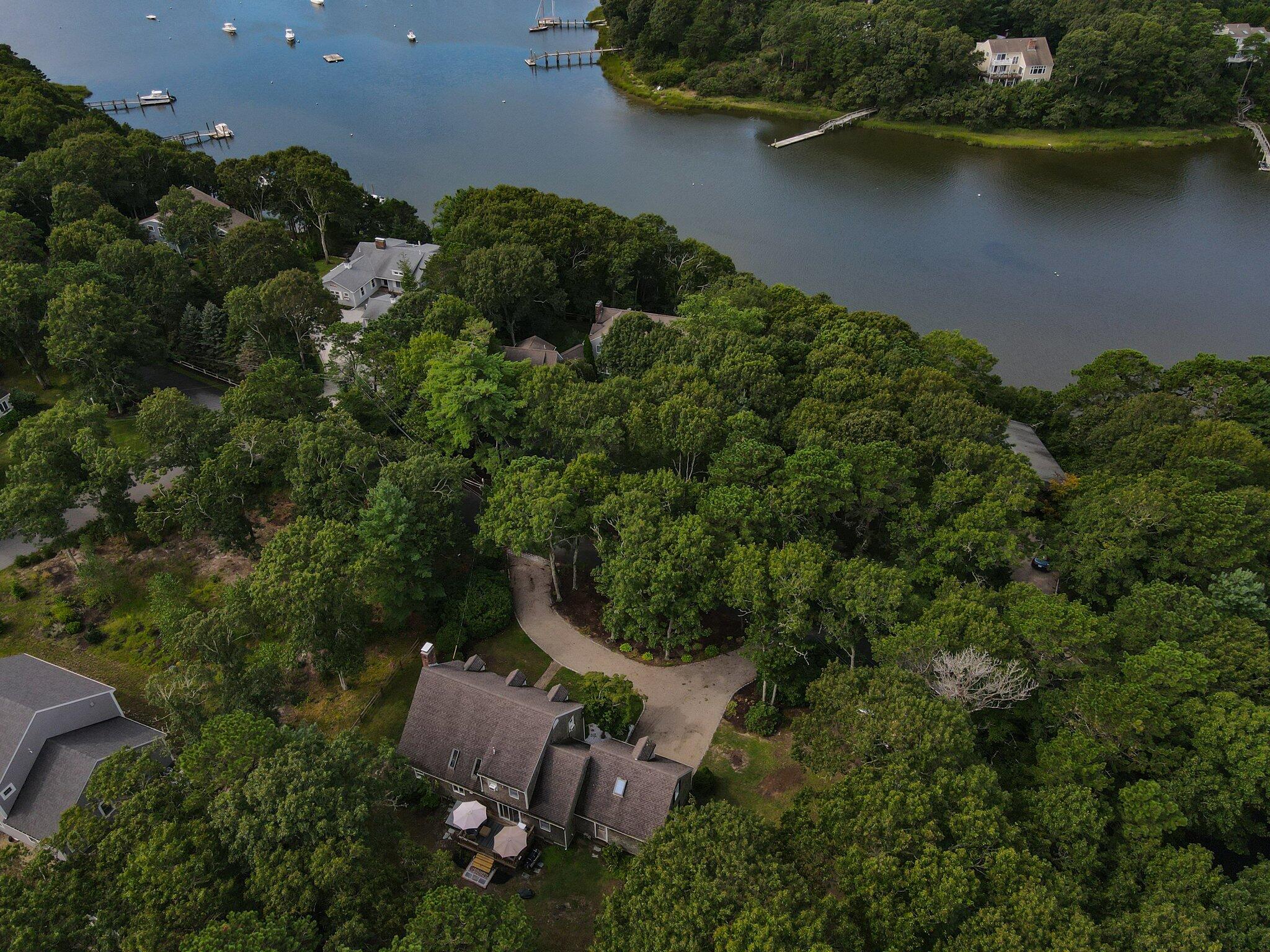 131 Clamshell Cove Road Cotuit, MA 02635 - Photo 2 of 67 an aerial view of a house with a yard and lake view