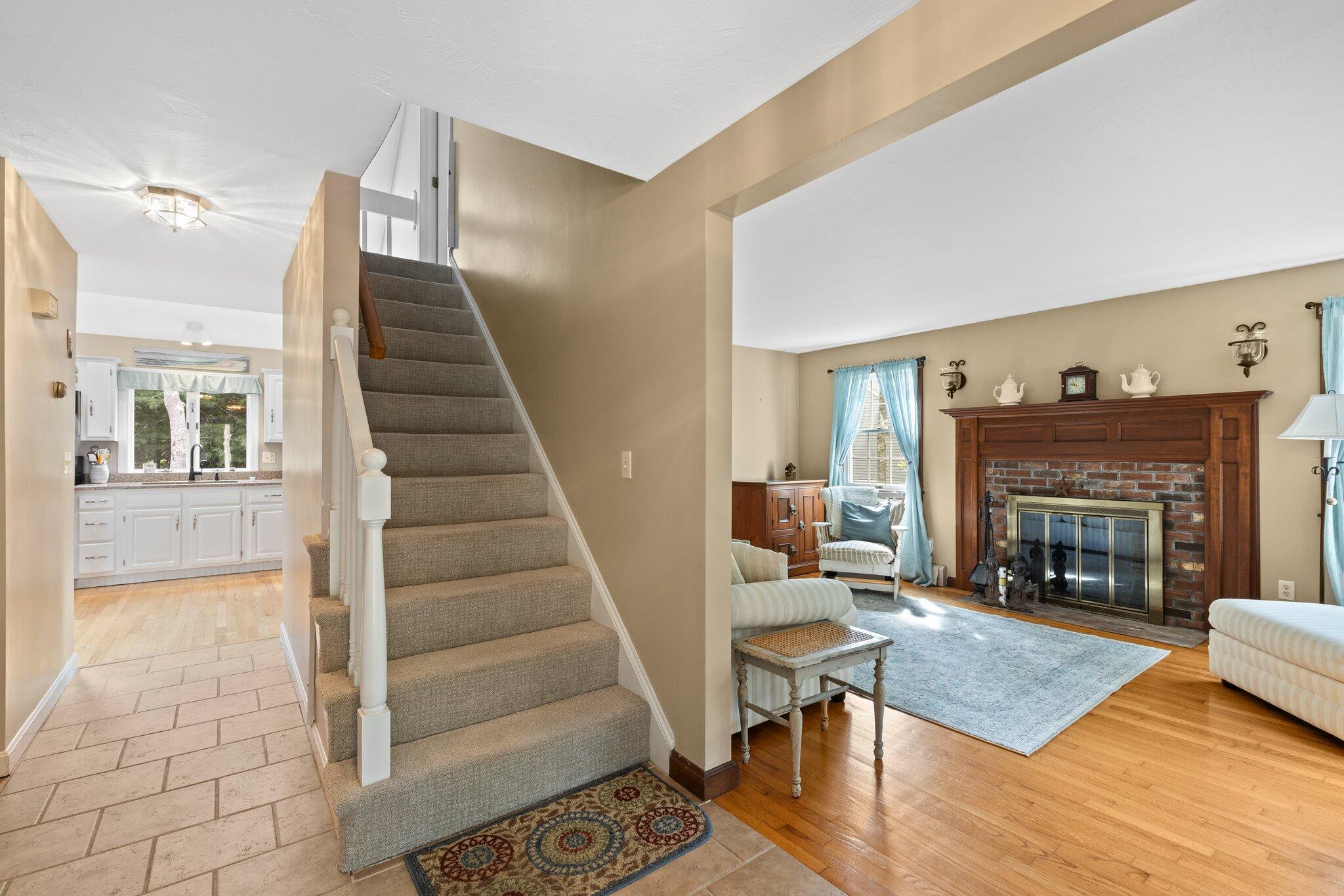 131 Clamshell Cove Road Cotuit, MA 02635 - Photo 25 of 67 a living room with furniture and a fireplace