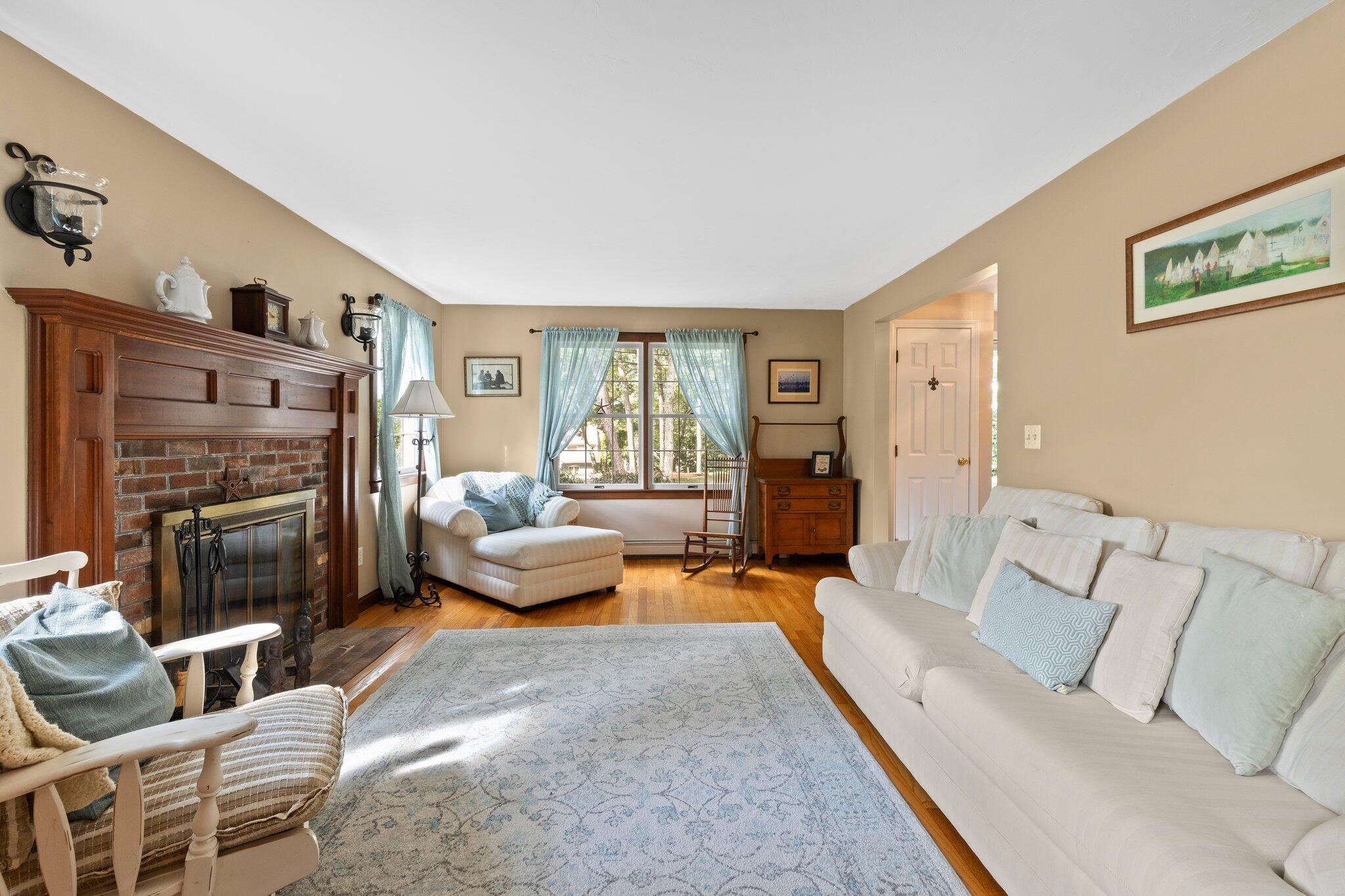 131 Clamshell Cove Road Cotuit, MA 02635 - Photo 28 of 67 a living room with furniture and a fireplace