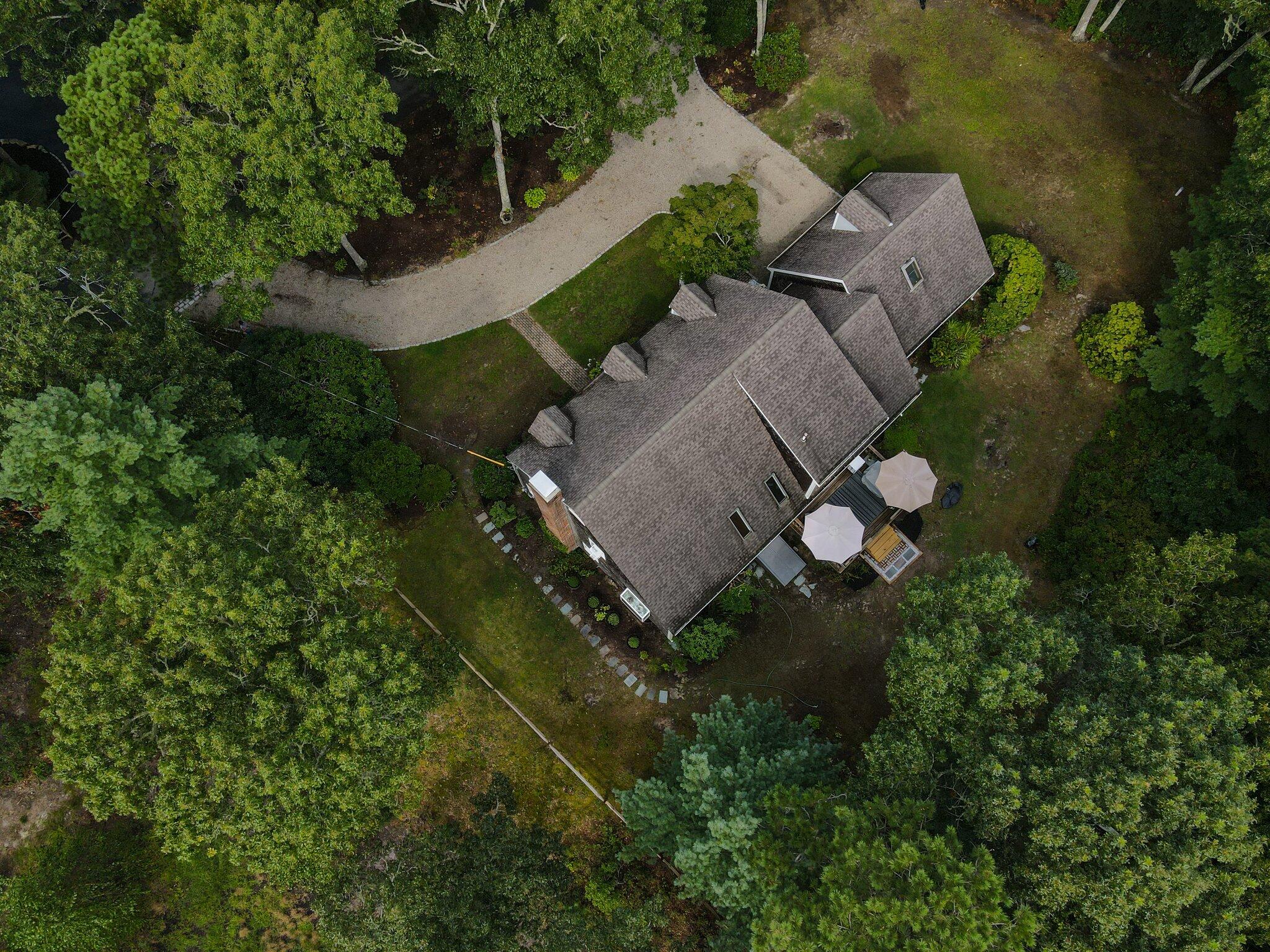 131 Clamshell Cove Road Cotuit, MA 02635 - Photo 3 of 67 an aerial view of a house with a yard