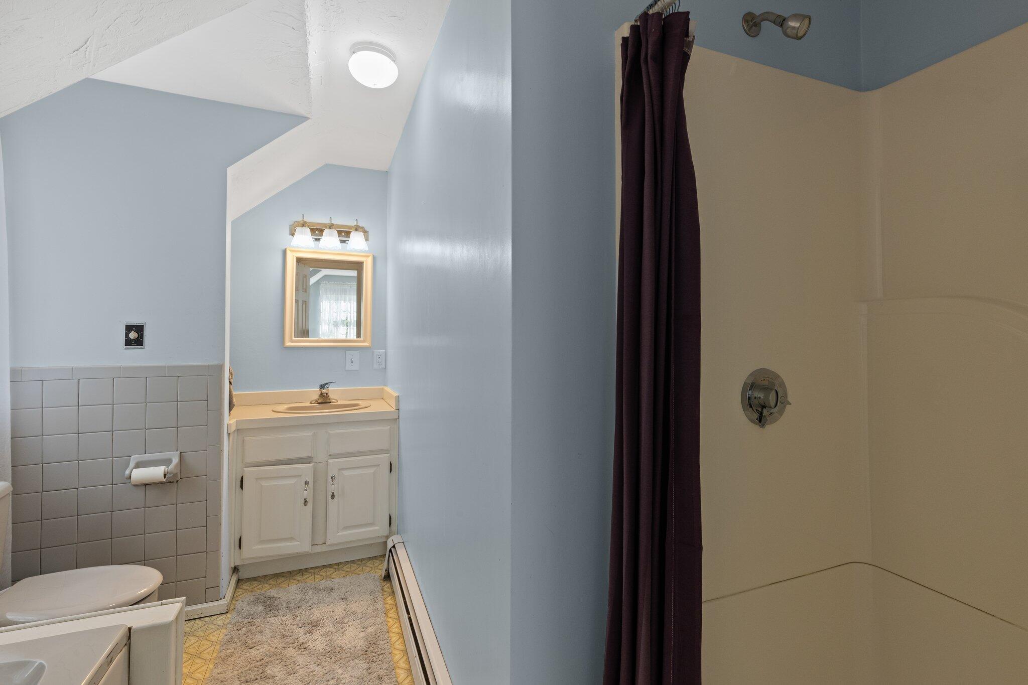 131 Clamshell Cove Road Cotuit, MA 02635 - Photo 41 of 67 a bathroom with a sink a toilet and shower