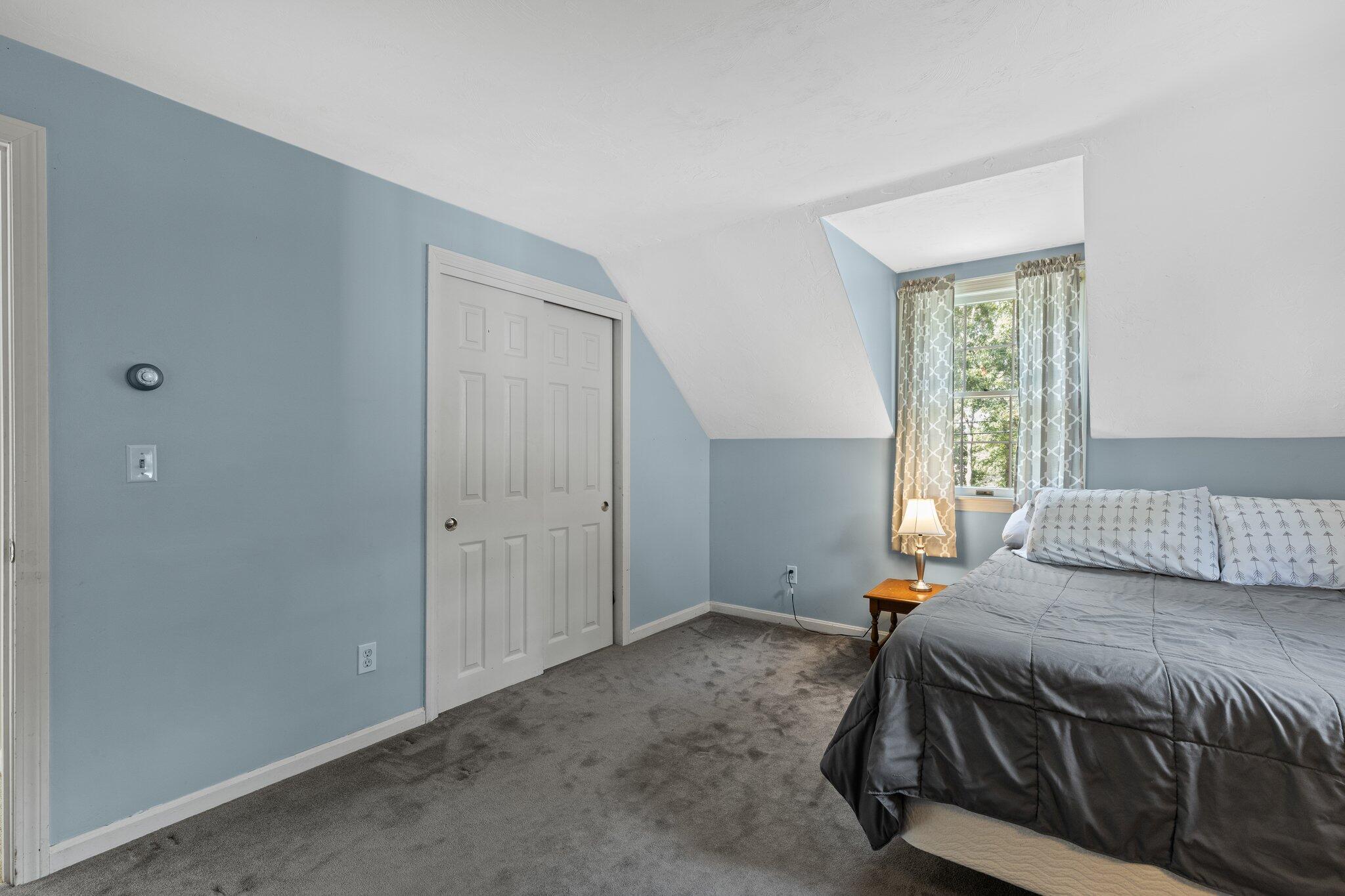 131 Clamshell Cove Road Cotuit, MA 02635 - Photo 43 of 67 a bedroom with a bed and a window