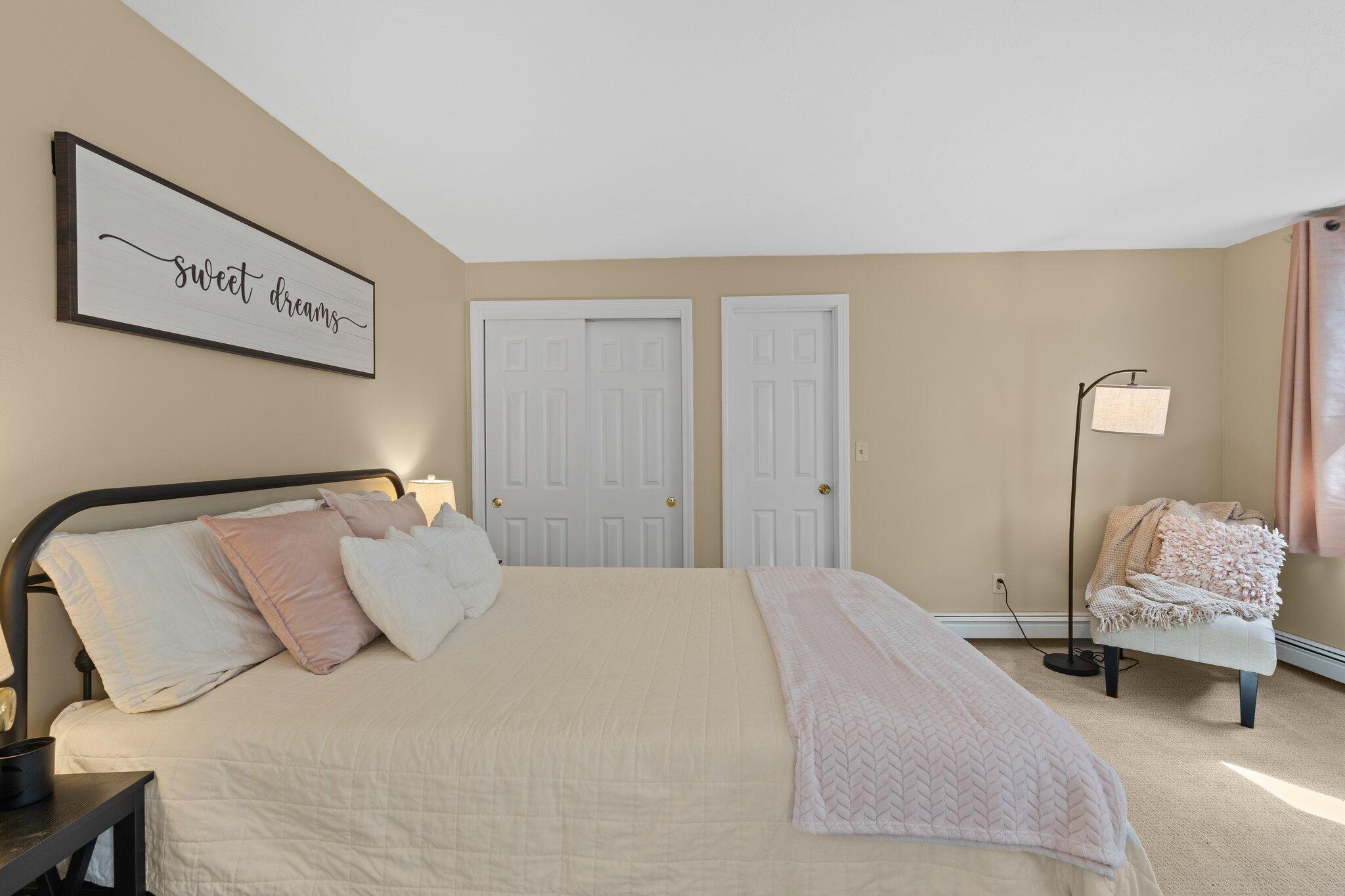 131 Clamshell Cove Road Cotuit, MA 02635 - Photo 45 of 67 a bedroom with a bed and a chair