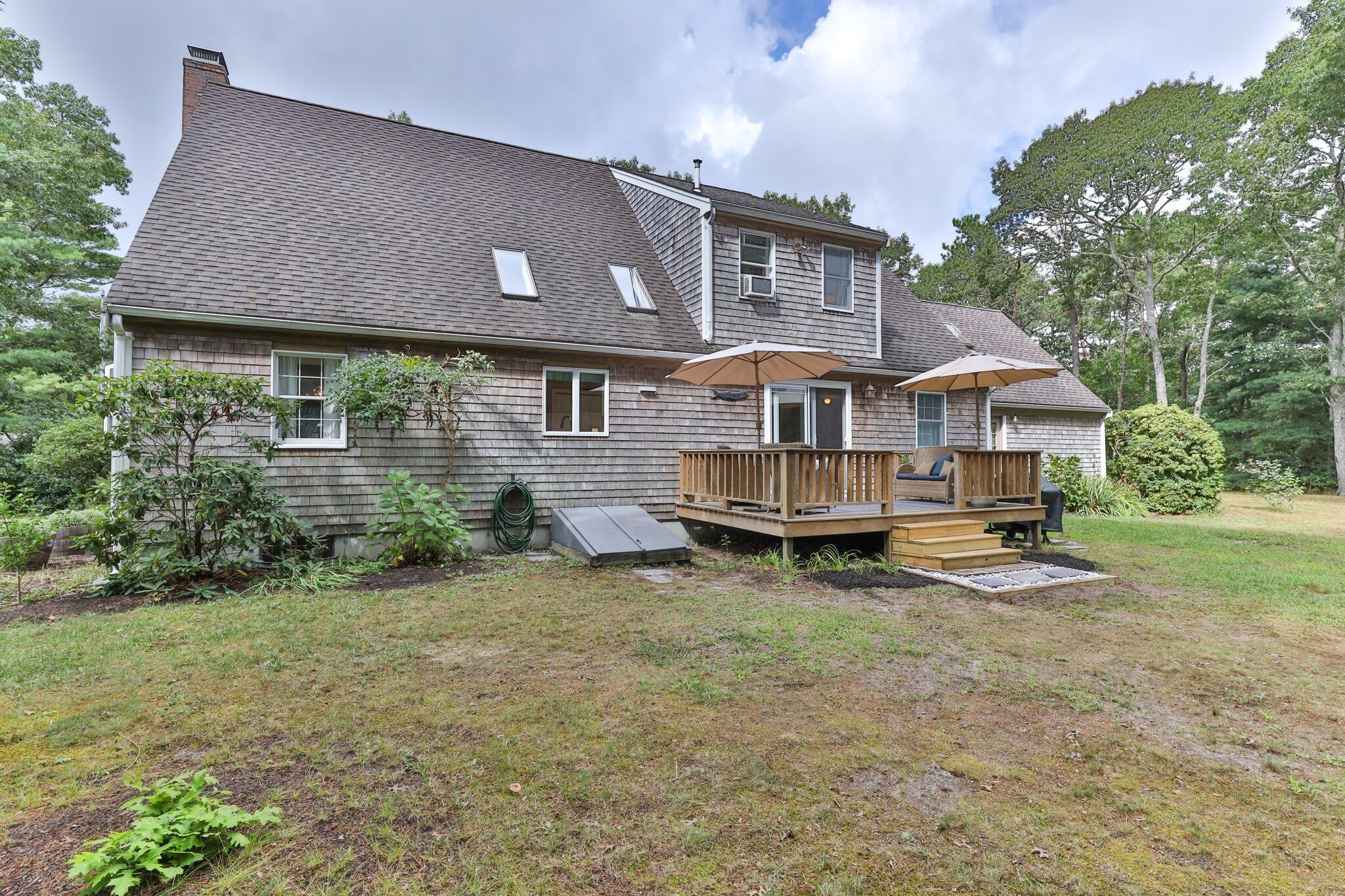 131 Clamshell Cove Road Cotuit, MA 02635 - Photo 54 of 67 a view of house with a big yard and large trees