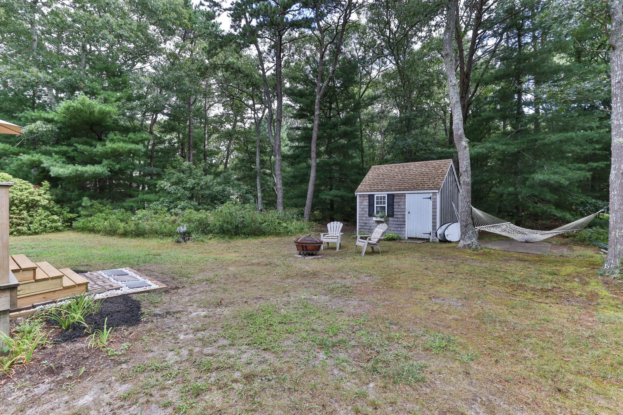 131 Clamshell Cove Road Cotuit, MA 02635 - Photo 57 of 67 a view of a house with backyard