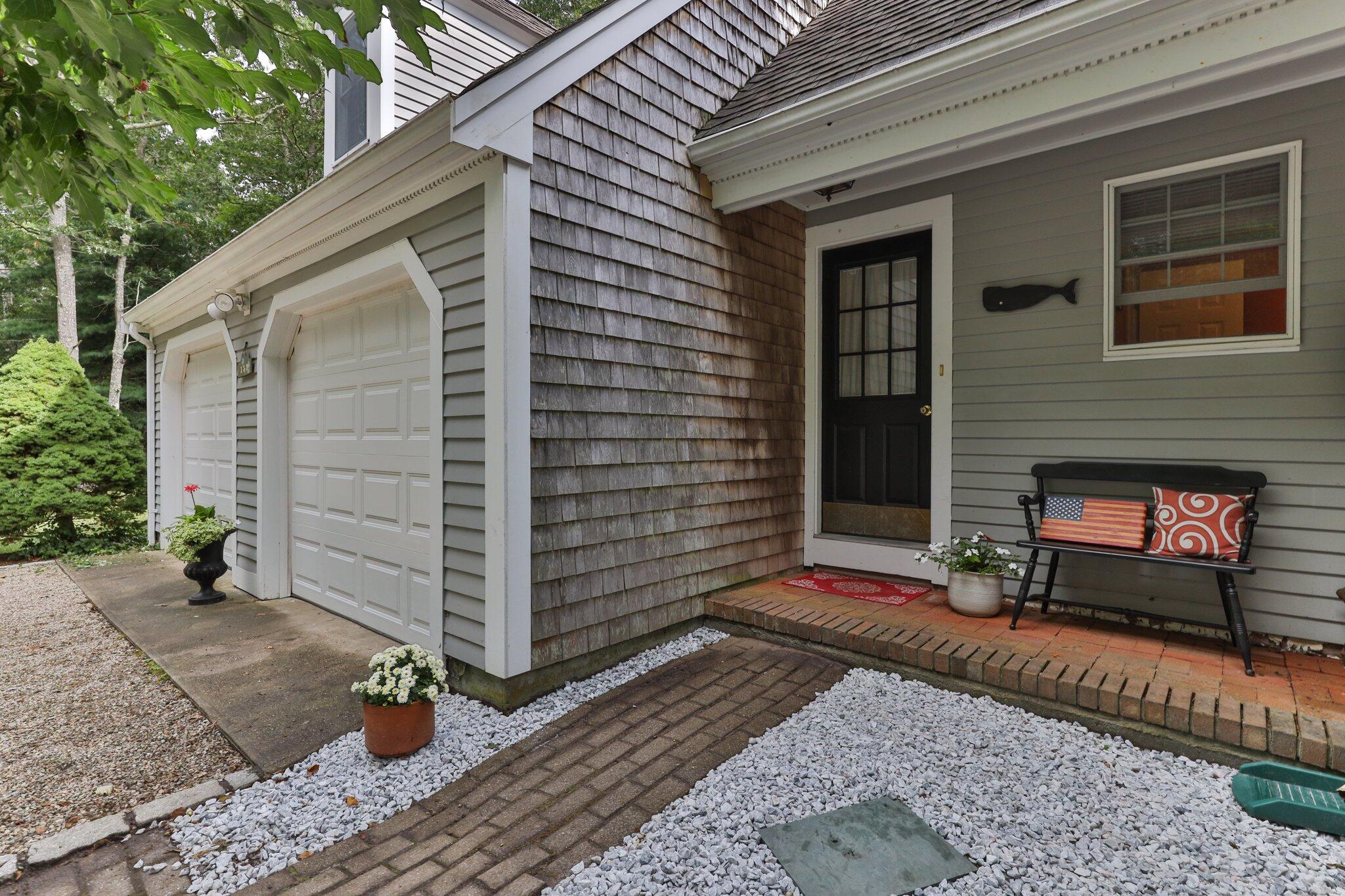 131 Clamshell Cove Road Cotuit, MA 02635 - Photo 9 of 67 a brick building with a window and a door