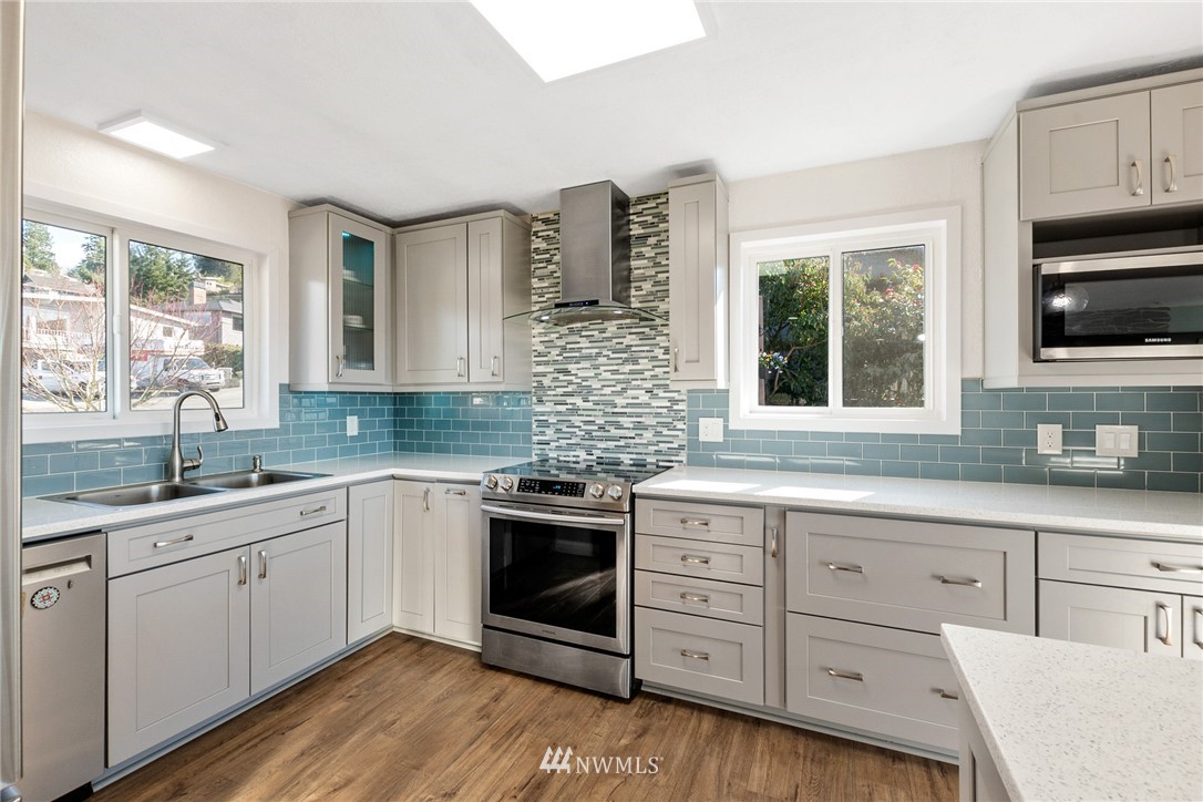 9337 45th Avenue Southwest Seattle, WA 98136 - Photo 11 of 30 a kitchen with sink cabinets and window