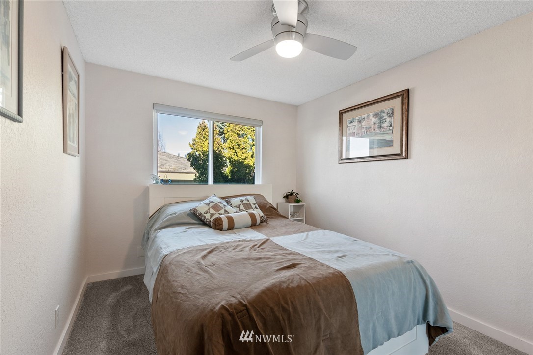 9337 45th Avenue Southwest Seattle, WA 98136 - Photo 15 of 30 a bedroom with a bed and a window