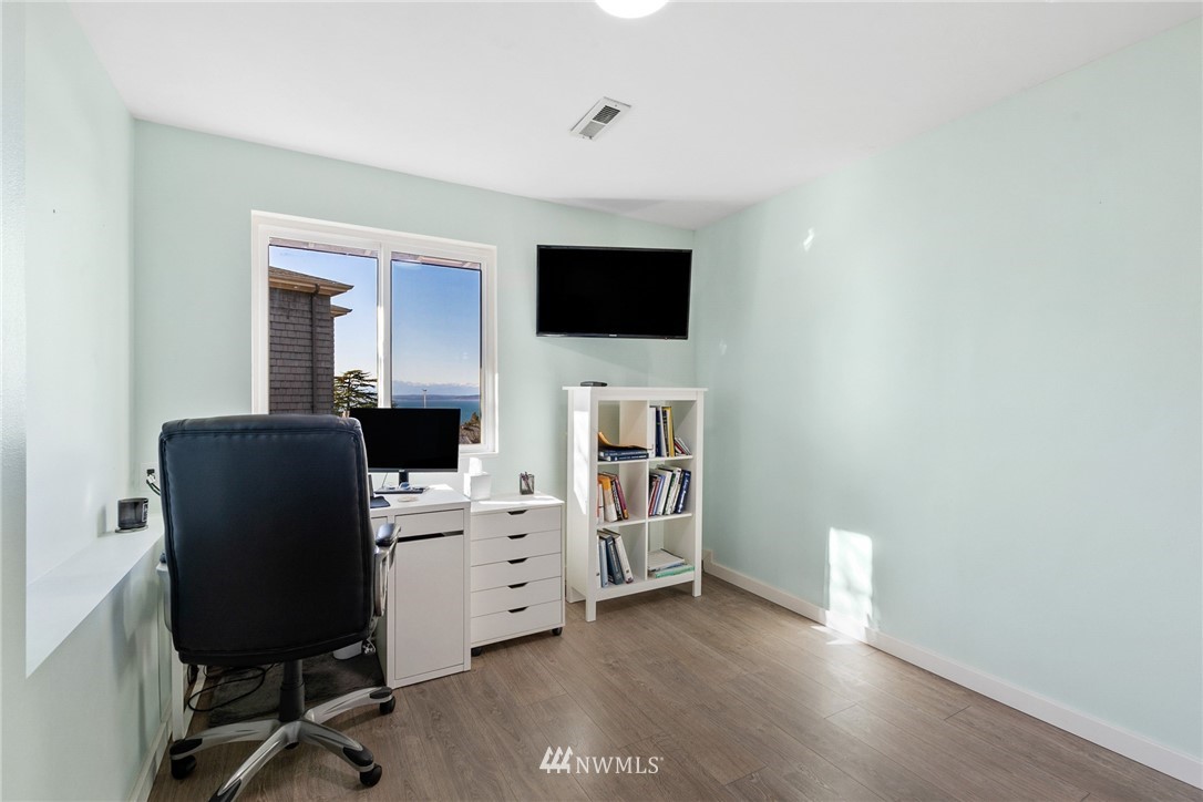 9337 45th Avenue Southwest Seattle, WA 98136 - Photo 17 of 30 a view of a workspace with furniture and a flat screen tv