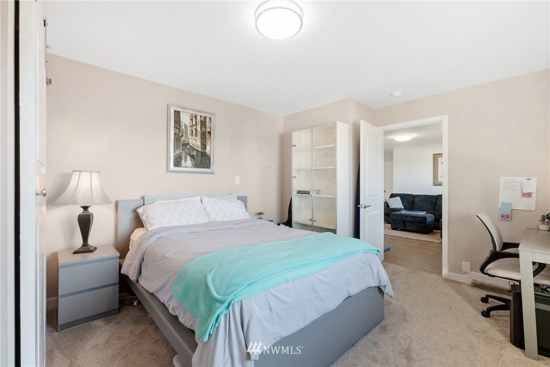 9337 45th Avenue Southwest Seattle, WA 98136 - Photo 18 of 30 a bedroom with a bed and a chair