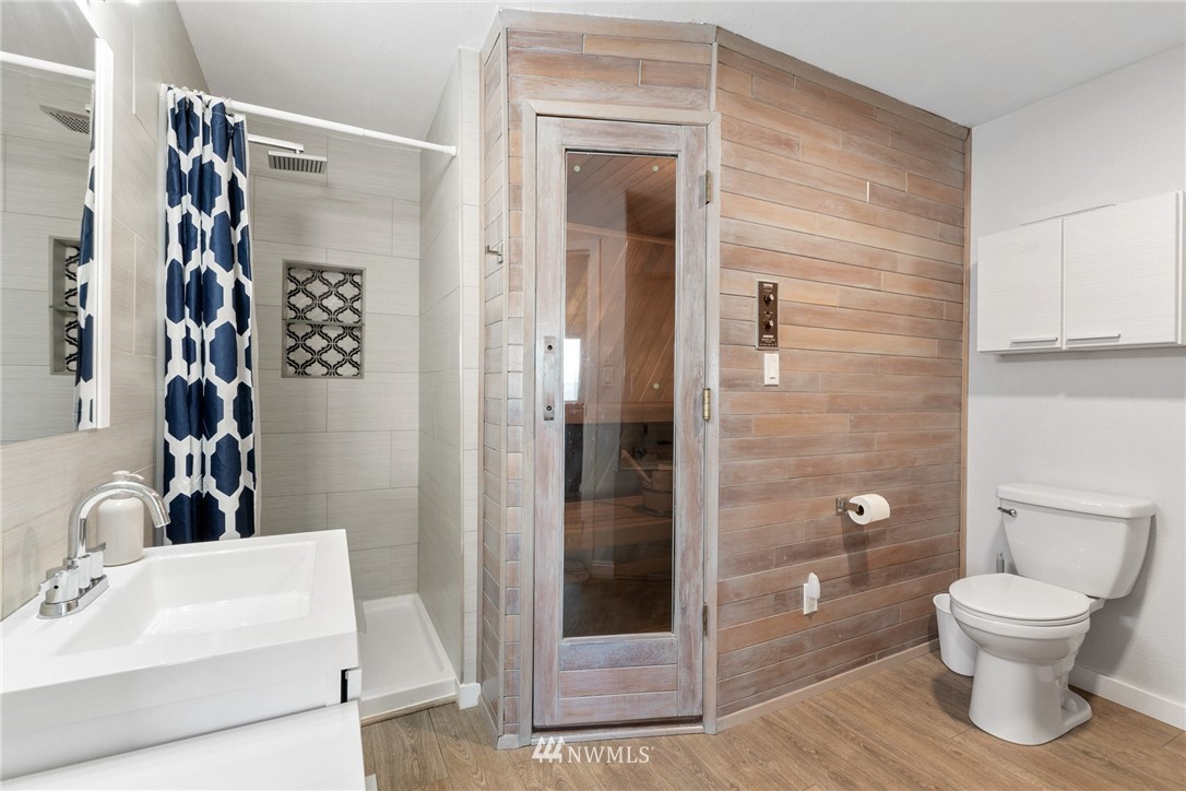 9337 45th Avenue Southwest Seattle, WA 98136 - Photo 19 of 30 a bathroom with a toilet a sink and shower