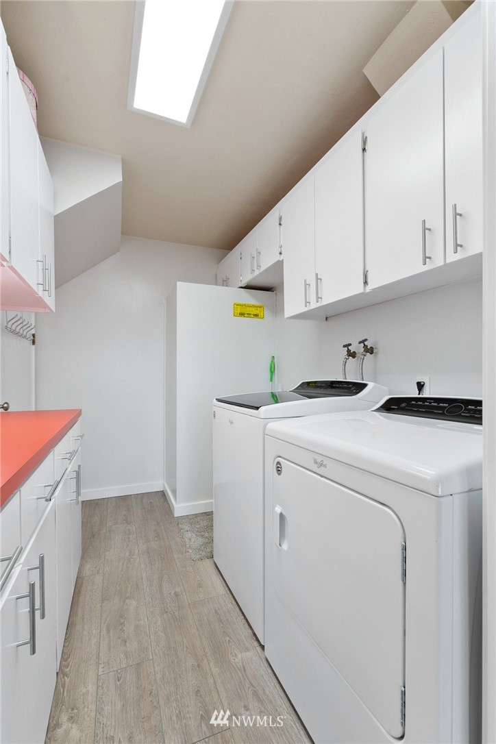 9337 45th Avenue Southwest Seattle, WA 98136 - Photo 20 of 30 a view of storage and utility room with washer and dryer