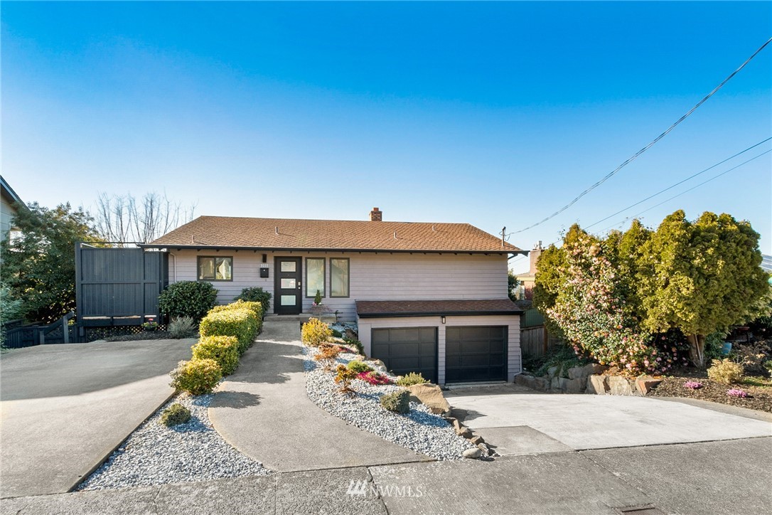 9337 45th Avenue Southwest Seattle, WA 98136 - Photo 2 of 30 a view of a house with a patio and a yard