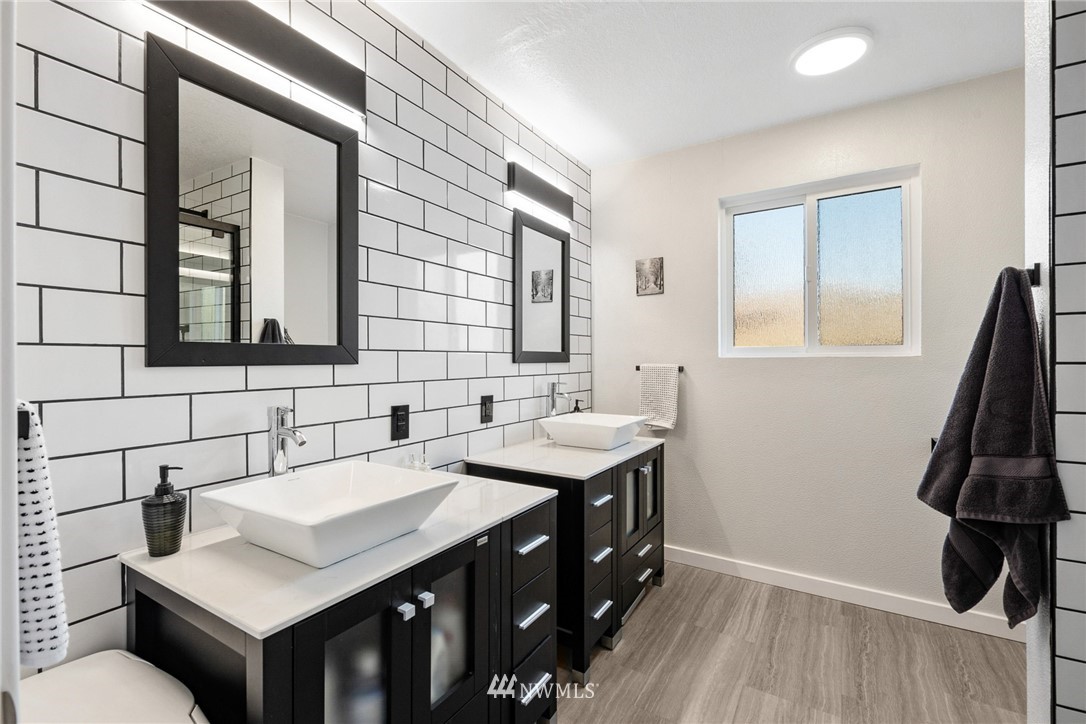 9337 45th Avenue Southwest Seattle, WA 98136 - Photo 6 of 30 a bathroom with a sink and a mirror