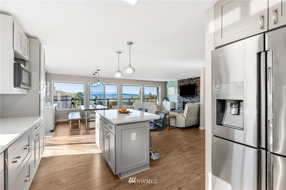 9337 45th Avenue Southwest Seattle, WA 98136 - Photo 8 of 30 a kitchen with stainless steel appliances granite countertop a refrigerator and a view of living room