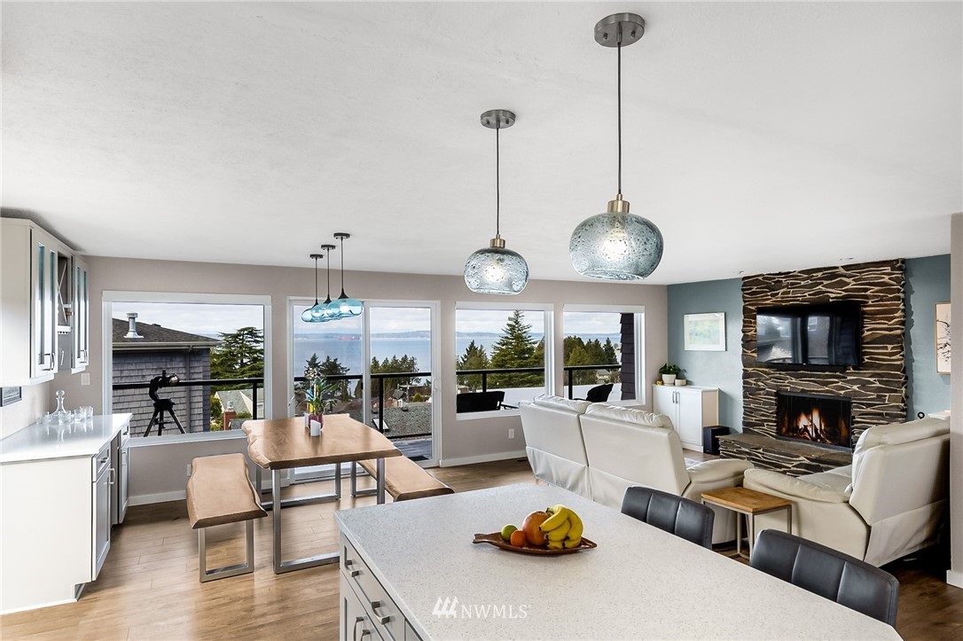 9337 45th Avenue Southwest Seattle, WA 98136 - Photo 9 of 30 a living room with furniture kitchen view and a wooden floor