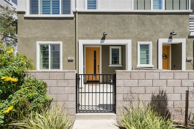 a view of a brick house with large windows