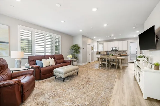 a kitchen with kitchen island wooden cabinets and stainless steel appliances