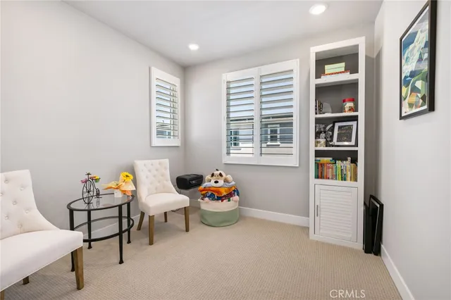 a view of a hallway with dining room and chair