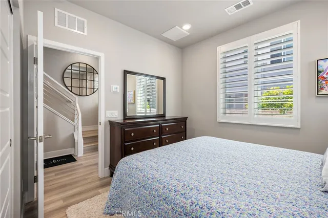 a bedroom with a bed dresser and a window