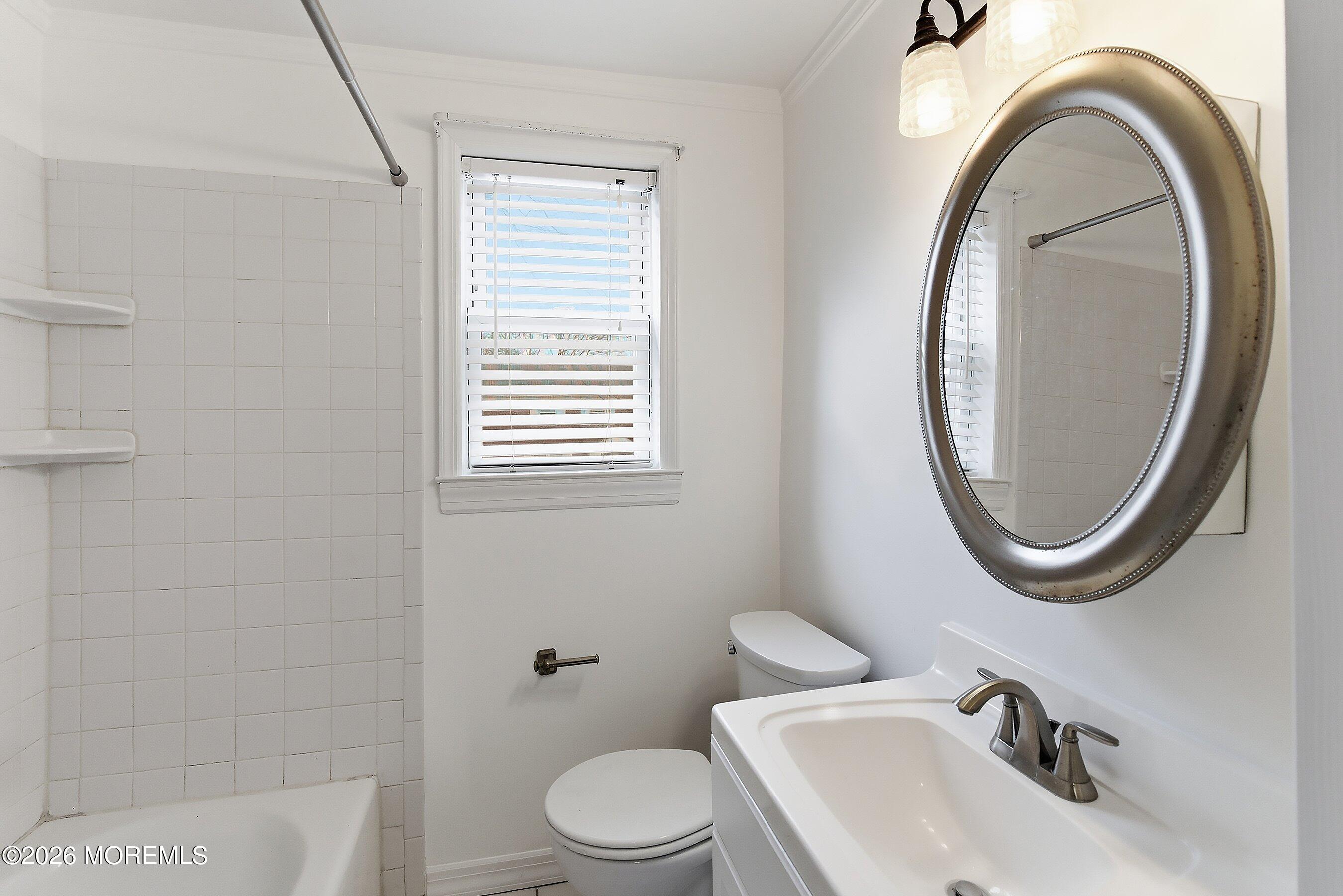 83 Manor Drive Red Bank, NJ 07701 - Photo 14 of 16 a bathroom with a sink a toilet and a mirror