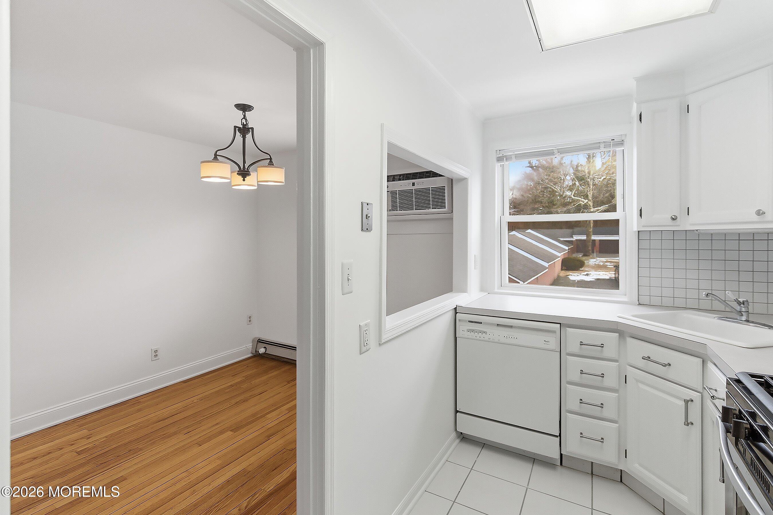 83 Manor Drive Red Bank, NJ 07701 - Photo 9 of 16 a kitchen with white cabinets and window