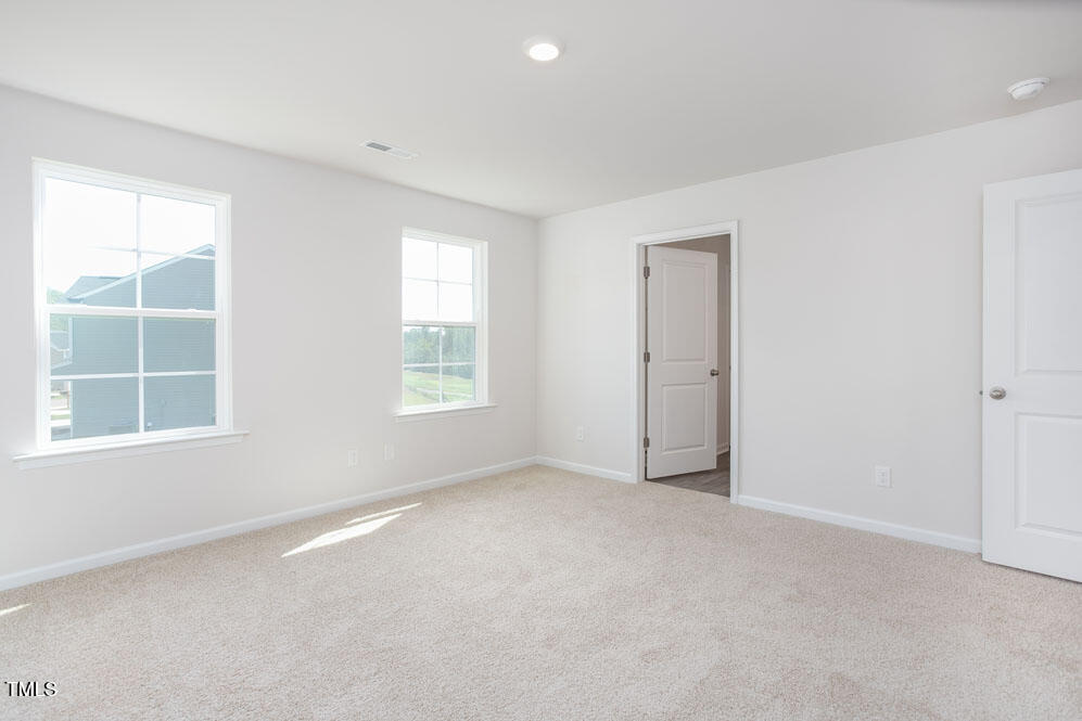 6048 Sodium Street Raleigh, NC 27610 - Photo 16 of 30 an empty room with a window