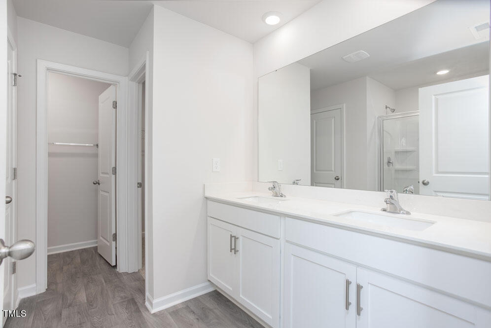 6048 Sodium Street Raleigh, NC 27610 - Photo 17 of 30 a bathroom with a sink double vanity granite tub and a mirror