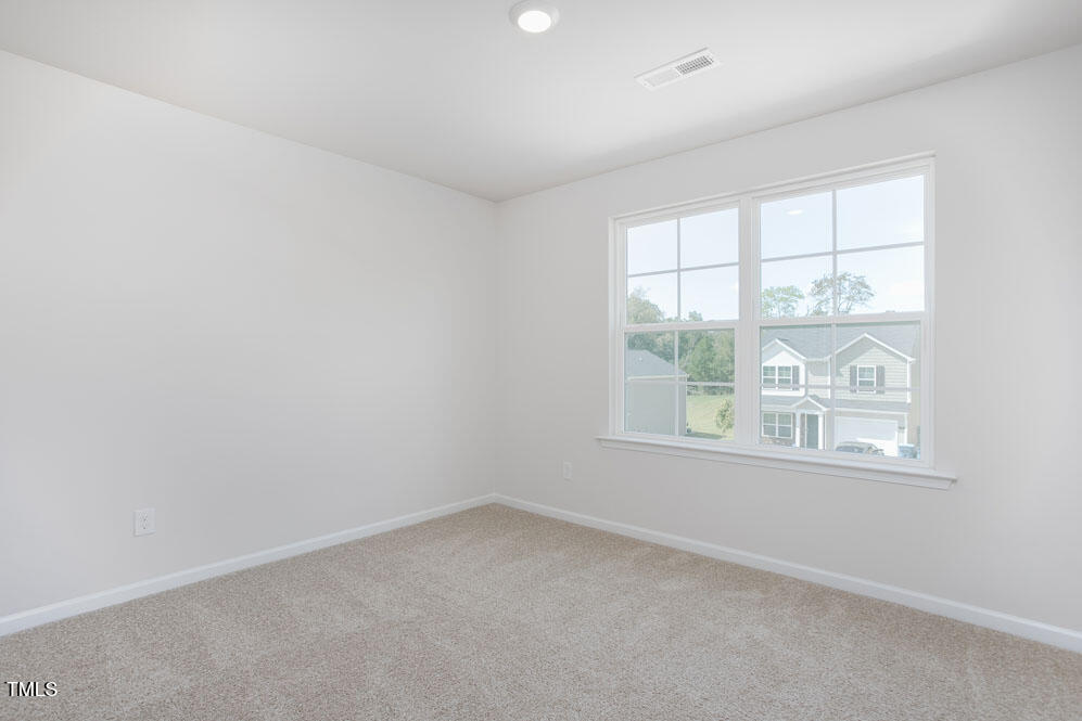 6048 Sodium Street Raleigh, NC 27610 - Photo 23 of 30 an empty room with a window