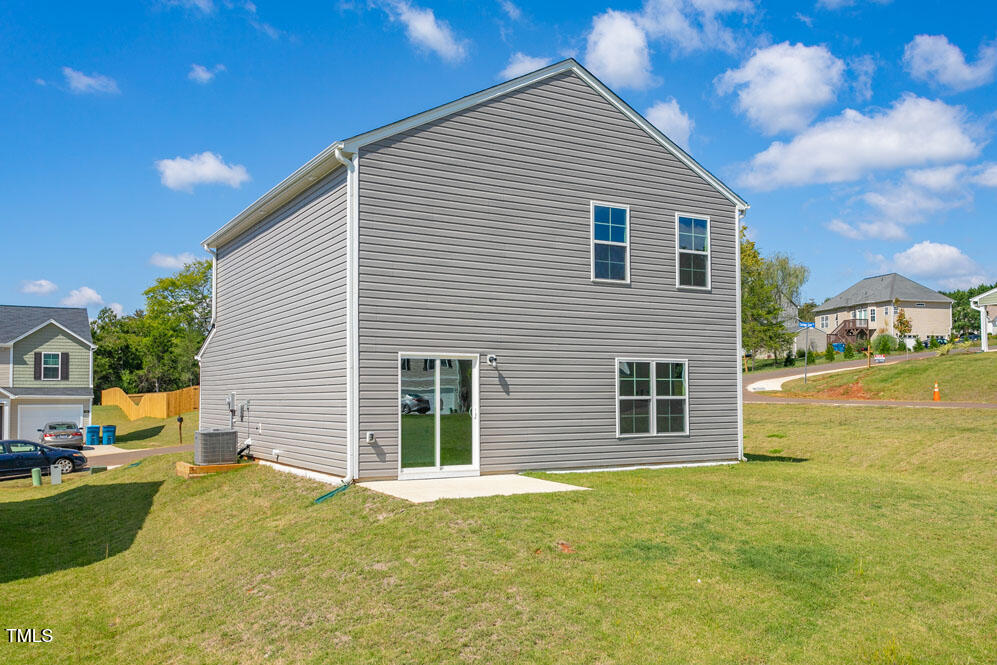 6048 Sodium Street Raleigh, NC 27610 - Photo 28 of 30 a view of a house with a yard and sitting area
