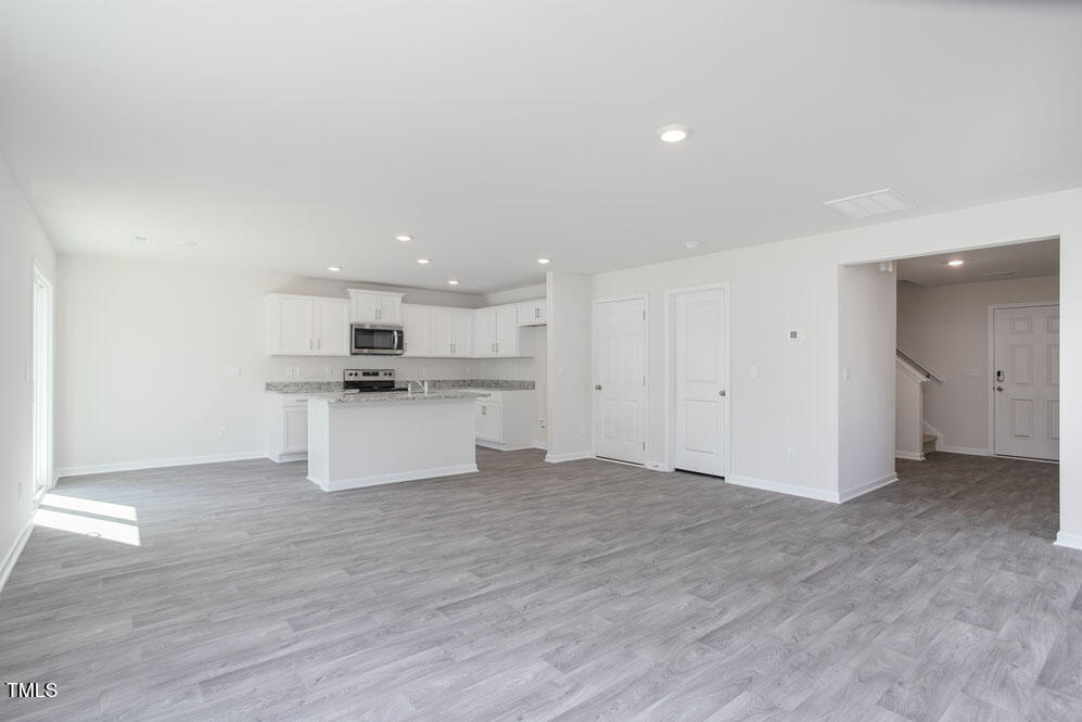 6048 Sodium Street Raleigh, NC 27610 - Photo 8 of 30 a view of kitchen with wooden floor