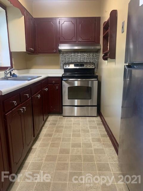 916 McAlway Road Charlotte, NC 28211 - Photo 2 of 9 a kitchen with a stove top oven cabinets and stainless steel appliances