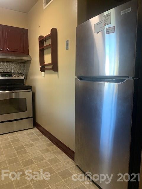 916 McAlway Road Charlotte, NC 28211 - Photo 4 of 9 a kitchen with a refrigerator and a stove top oven