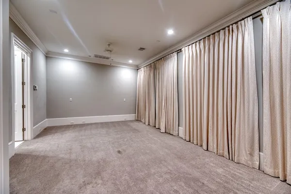 an empty room with closet and a ceiling fan