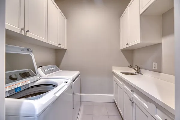 a bathroom with a bathtub and double sink