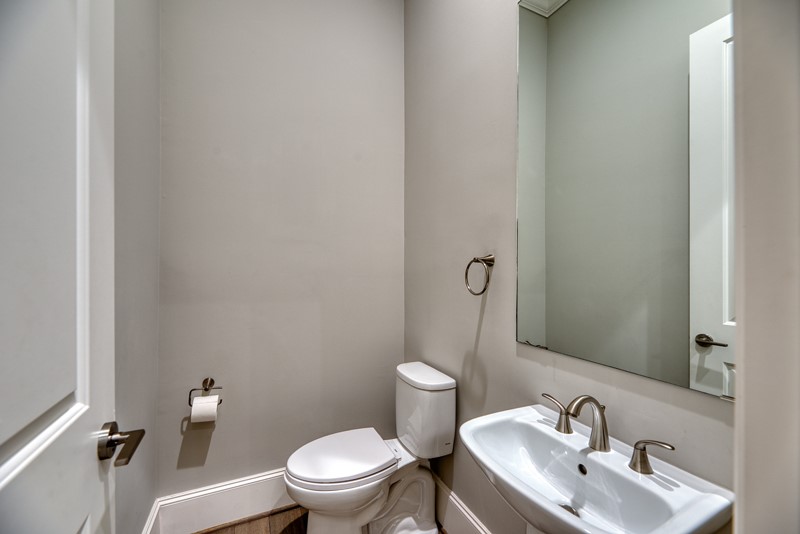 1913 Revere Street Houston, TX 77019 - Photo 23 of 40 a bathroom with a toilet sink and mirror