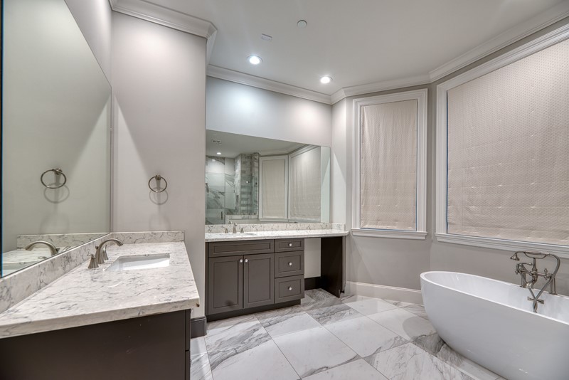 1913 Revere Street Houston, TX 77019 - Photo 26 of 40 a bathroom with a granite countertop sink mirror and bathtub