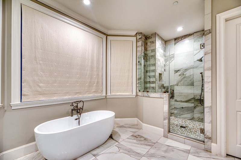 1913 Revere Street Houston, TX 77019 - Photo 28 of 40 a bathroom with a bathtub and shower