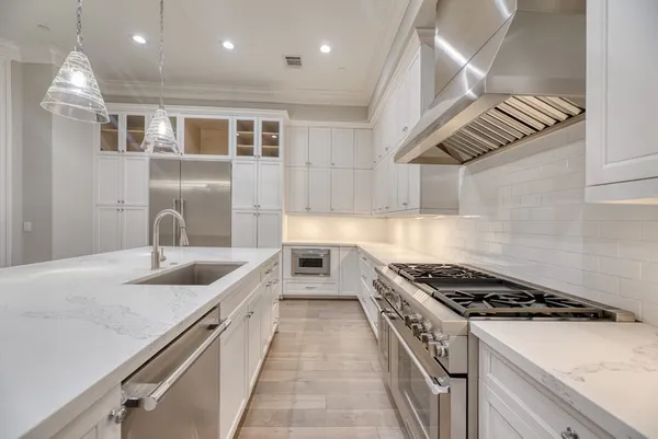 a kitchen with stainless steel appliances granite countertop a sink and stove