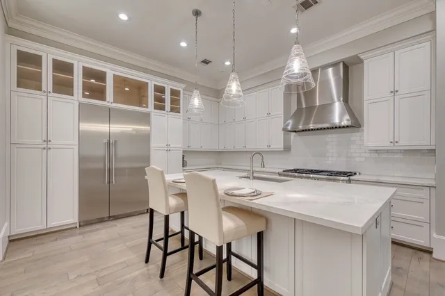 a kitchen that has a table and chairs in it