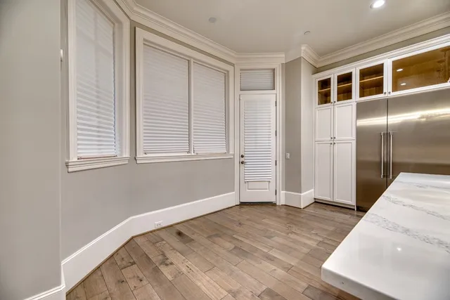 a view of empty room with wooden floor