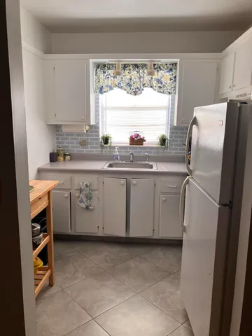 a kitchen with stainless steel appliances a sink cabinets and a refrigerator